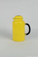 Full front view of yellow Bodum jug with handle