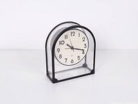 Front angled view showing transparent body, black frame, dial