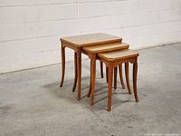 Set of three walnut nesting tables stacked