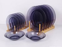 Full set of amethyst glass plates and bowls on racks