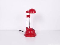 Full view of red halogen desk lamp