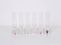 Front view of six shooter glasses showing different colored inclusions in bases