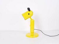 Full side view of yellow KRUX lamp showing base, body, shade and cord