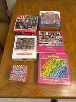 Six puzzle packages arranged on table