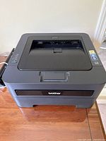 Top view of Brother laser printer showing control panel and output slot