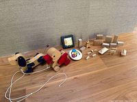 Full lot view showing two pull toys, ring rattle, block set, picture tile