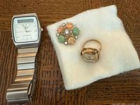 Group shot showing Seiko watch, ring watch and brooch