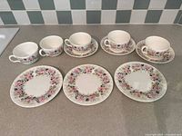 Full set of cups, saucers and plates on countertop