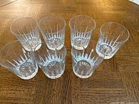 Seven crystal tumblers arranged together showing overall style