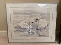 grayscale print of two swans in silver frame