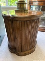 Front view of wooden drum side table showing fluted exterior and top surface