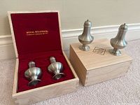 Two Royal Selangor shakers in open wood box, second closed box beside