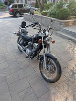 Front three-quarter view of motorcycle showing overall condition, headlight, front wheel, and handlebars