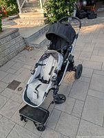 Front angle view of Baby Jogger City Select stroller with ride-on board attached