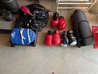 Overall view of gloves, pads, shoes, mat and speed bag platform