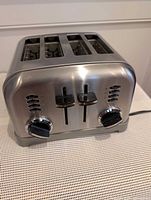 Front view showing four slots, dual controls and dials