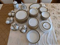 Overview of complete dinnerware set laid on table