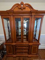 Front view of closed china cabinet showing overall design and wood finish