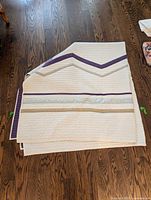 Folded quilt showing geometric stripe pattern