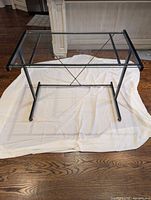 Full view of desk showing glass top and metal frame