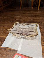 top view of clear freeform glass bowl with gold rim