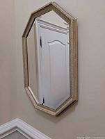 Front view of octagonal mirror hanging on wall