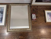Front view of rectangular ornate framed mirror placed on floor