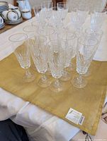 All 11 crystal champagne flutes grouped on cloth