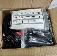 Box containing coiled tubing and bags of components with instruction sheet