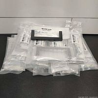 Stack of individually bagged satin black handles