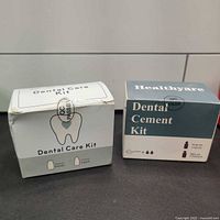 Two boxed dental repair kits side by side