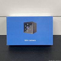 Front of blue retail box showing mini camera image and label