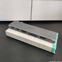 Full view of hub resting atop box, showing overall shape and finish