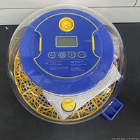 Top view showing control panel, LCD screen, and interior egg tray