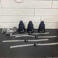 Three fan bases, hubs, blades and accessory bags displayed on counter