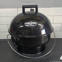 Front view of Kingsford 14" portable charcoal grill
