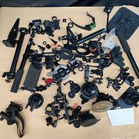 Full lot spread of assorted mounts, clamps, poles, phone holder and accessories