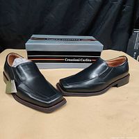 Both shoes with original box visible