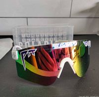 Front view of sunglasses showing lens, frame and logo