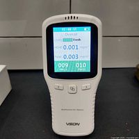 Front view of powered-on VSON air quality monitor showing LCD with green reading screen