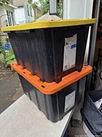 Two stacked HDX totes showing yellow and orange lids