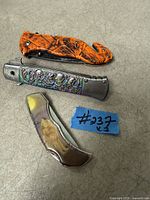Three closed folding knives showing handle designs