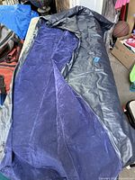 Intex double air mattress partially unfolded showing flocked blue top and grey vinyl sides