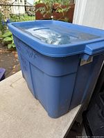 Side view of blue Rubbermaid tote with lid