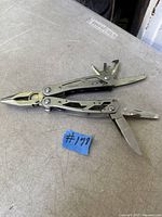 Multitool open showing pliers, knife, saw, file, and screwdrivers