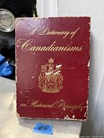 Front of dust-jacketed book showing title, crest and wear