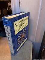 Front and spine view of the hardcover book showing title and publisher