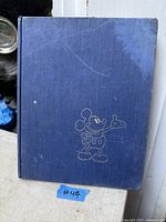 Front cover of blue cloth hardcover with Mickey Mouse line art