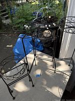 Stand unfolded showing four circular pot holders at varying heights