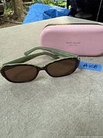 Sunglasses and case displayed on surface